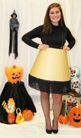image of a woman wearing a leg lamp costume surrounded by halloween decor
